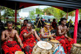 some ghana diaspora at cultural event with troops playing drums