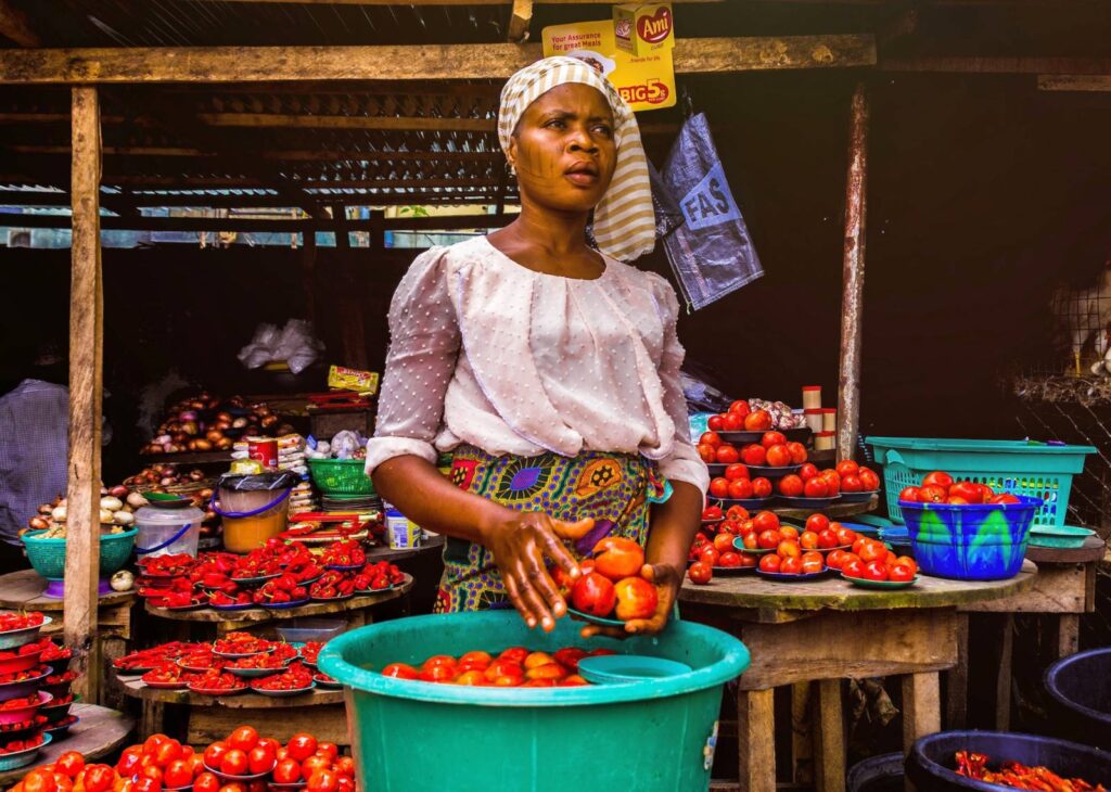 market woman in ghana selling tomatoes